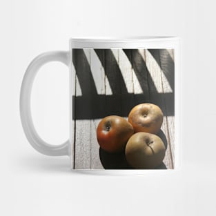 Three apples on a chair Mug